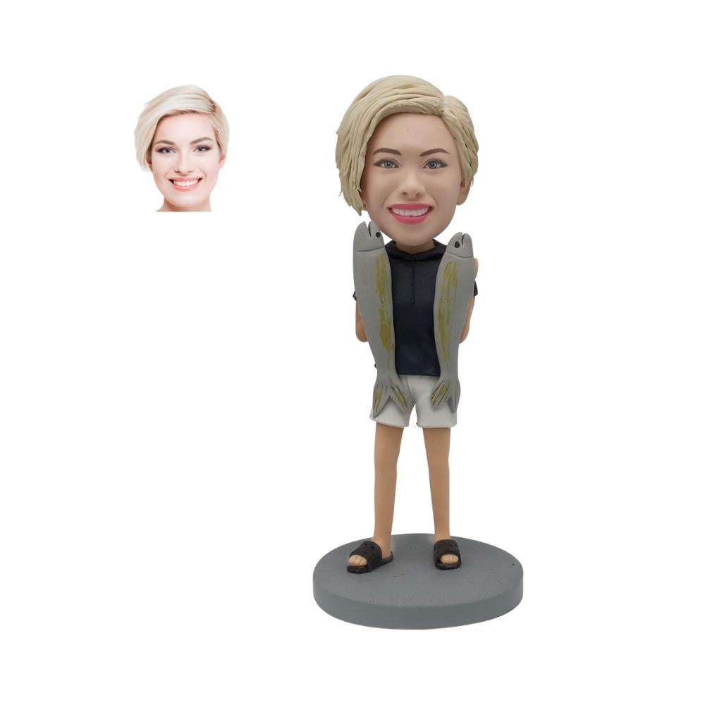 Custom bobblehead of a lady holding two fishs